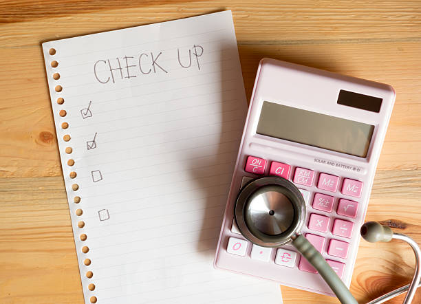 Pen marking a paper checklist